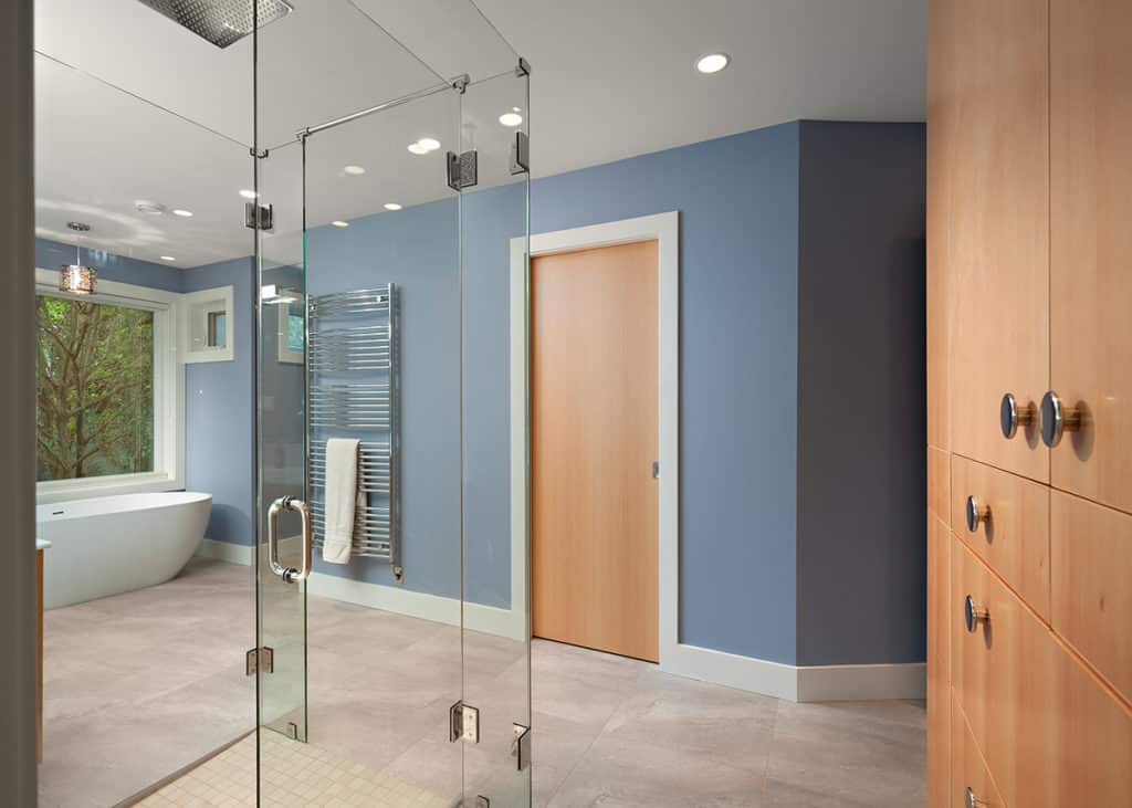 Balmoral bathroom after renovation, a freestanding tub at the window beside a glass shower and wood cabinetry.
