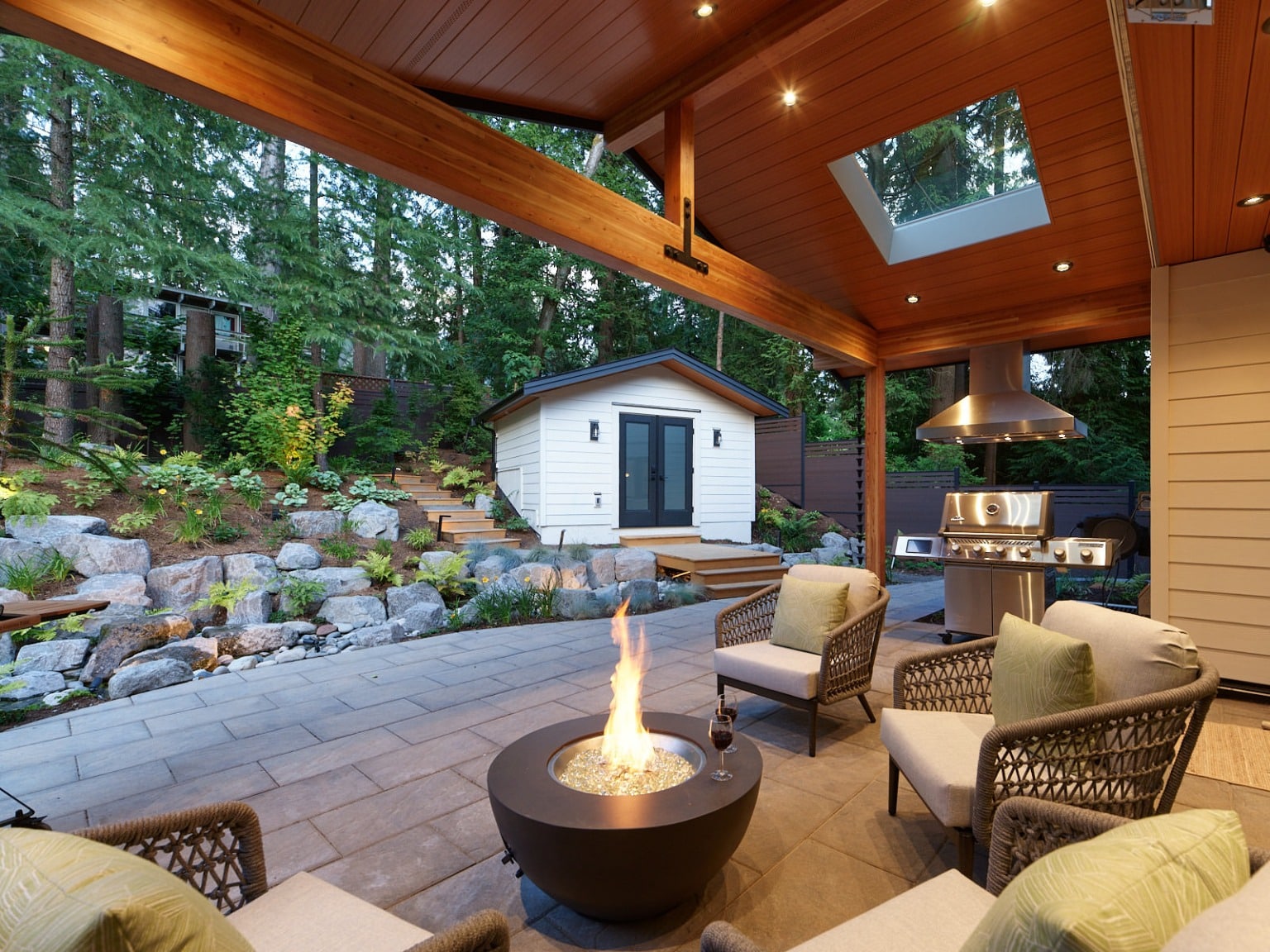 Covered outdoor room with a fire table and timber posts