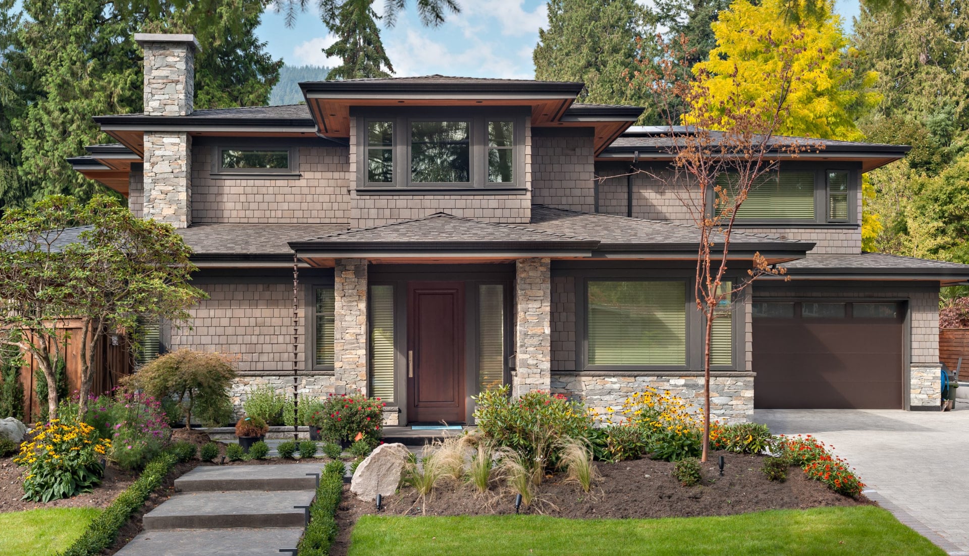 Shingle and stone custom home with deep eaves and mature landscaping, North Vancouver