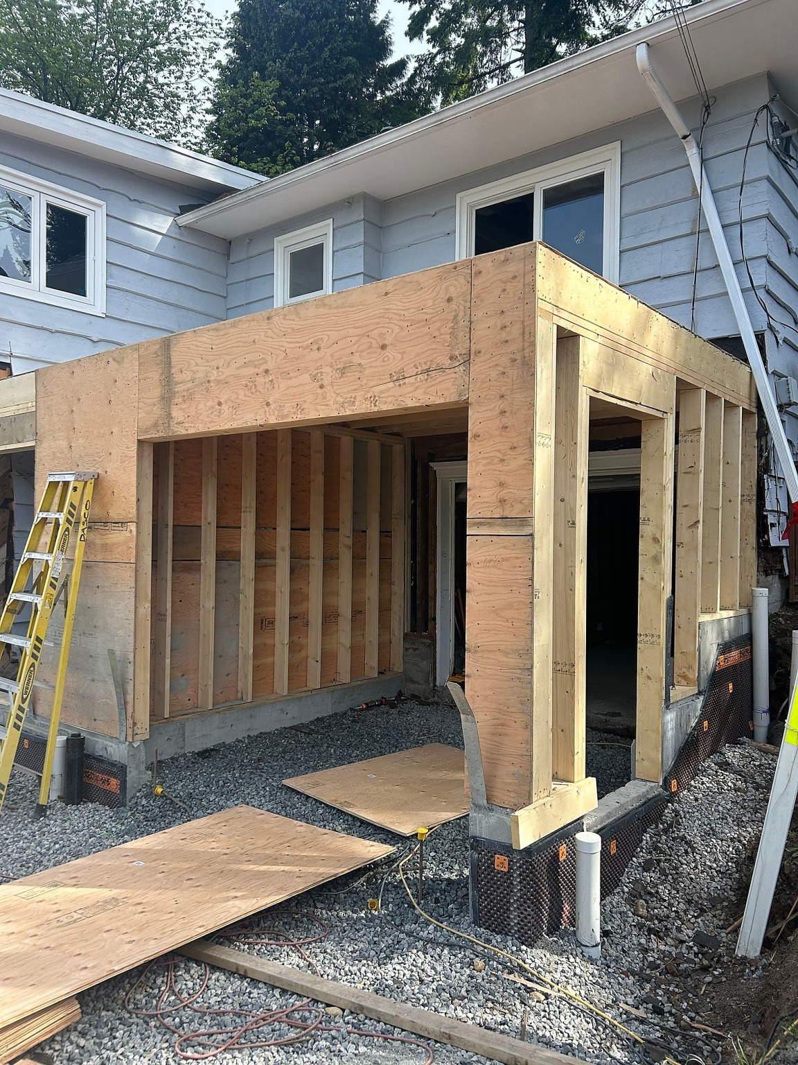 The framed garage addition against the original house