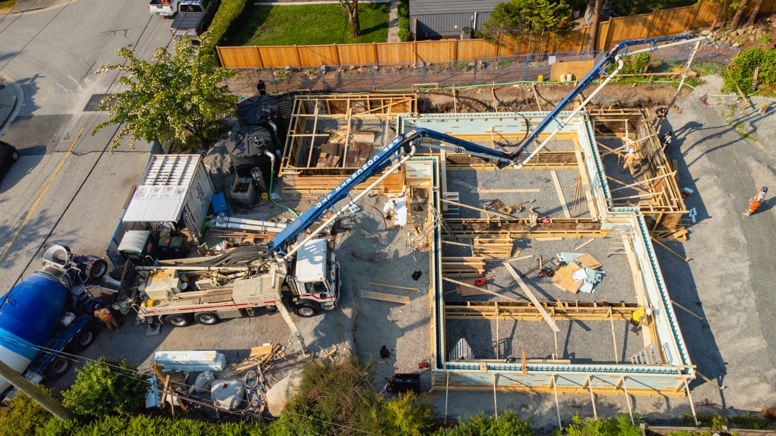 An aerial view of a concrete pump placing a foundation pour on a North Vancouver site